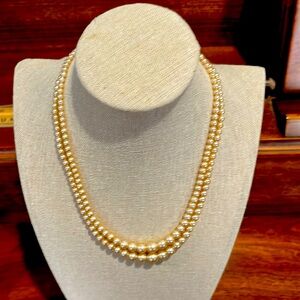 Vintage costume jewelry double strand pearl necklace, warm colour.